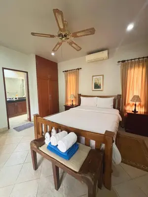 a bedroom with a bed with towels on a table at Luxury 3-bedroom villa with pool in Rawai in Rawai Beach