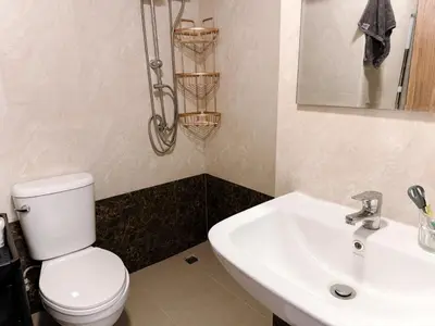 a bathroom with a white toilet and a sink at FAMILY HOMES Panoramic Pool View Studio in Mai Khao CB-706 in Ban Mai Salae