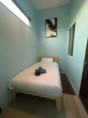 a small bedroom with a bed in a room at Villa Bang Tao Ananda Lake View in Ban Pak Lak