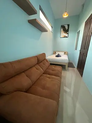 a living room with a couch and a bed at Villa Bang Tao Ananda Lake View in Ban Pak Lak