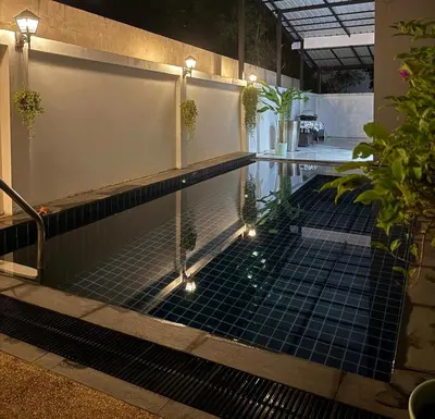 a pool with lights and plants in a building at Villa Bang Tao Ananda Lake View in Ban Pak Lak