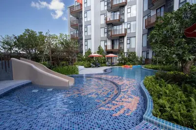 a swimming pool with a slide in a hotel at Canvas 1112 TwoBedroom Residence in Phuket Town