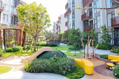 a playground with a slide in a park with buildings at Canvas 1112 TwoBedroom Residence in Phuket Town