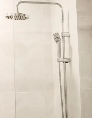 a shower with a shower head in a bathroom at Canvas 1112 TwoBedroom Residence in Phuket Town