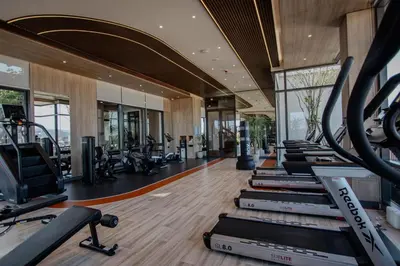 a gym with a row of treadmills and ellipticals at Canvas 1112 TwoBedroom Residence in Phuket Town