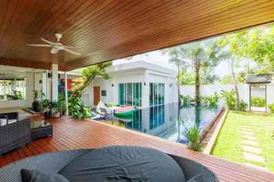 an open deck with a pool and a house at Peaceful Villa 12 mins to Bangtao & Layan Beach in Ban Pak Lak