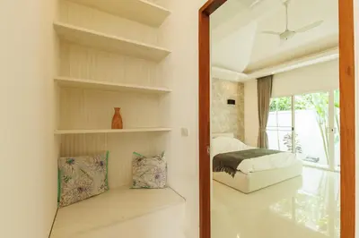 a bedroom with a bed and a mirror at Peaceful Villa 12 mins to Bangtao & Layan Beach in Ban Pak Lak