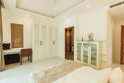a bedroom with a bed and a sink and a desk at Peaceful Villa 12 mins to Bangtao & Layan Beach in Ban Pak Lak