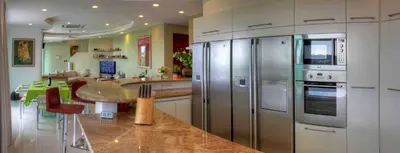 a kitchen with stainless steel appliances and a table at Villa Neptune Phuket - Luxury 6BR with Private Pool, Chalong in Ban Klang