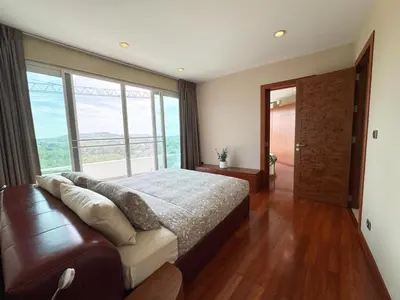 a bedroom with a large bed and a large window at Villa Neptune Phuket - Luxury 6BR with Private Pool, Chalong in Ban Klang