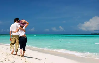 a man and a woman walking on the beach at Villa Neptune Phuket - Luxury 6BR with Private Pool, Chalong in Ban Klang