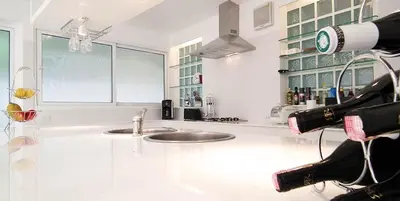 a kitchen with two sinks and a counter with a camera at Mango Villa in Ban Pa Khlok