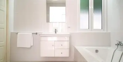 a white bathroom with a sink and a mirror at Mango Villa in Ban Pa Khlok