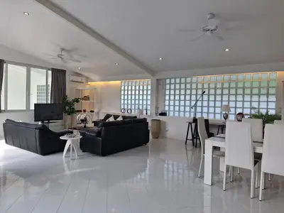 a living room with a couch and a table at Mango Villa in Ban Pa Khlok