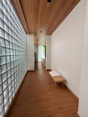 a hallway with a bench and a brick wall at New 3 Bed Villa Mono Oxygen Bangtao in Ban Thalat Choeng Thale