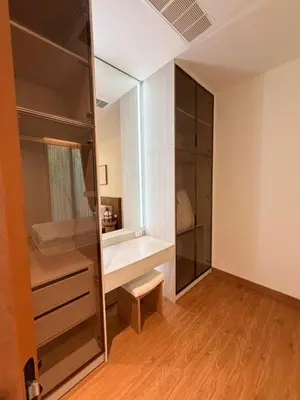 a walk in closet with a mirror and a stool at New 3 Bed Villa Mono Oxygen Bangtao in Ban Thalat Choeng Thale