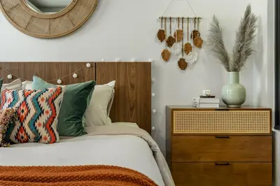 a bedroom with a bed with a wooden headboard and a mirror at Spacious studio with big patio ! in Rawai Beach
