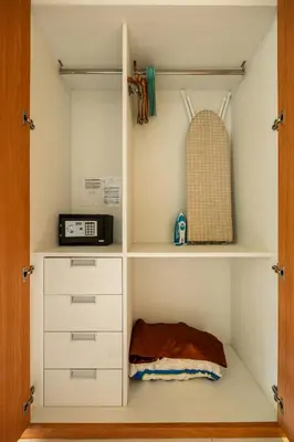 a closet with white drawers and a microwave at Spacious studio with big patio ! in Rawai Beach
