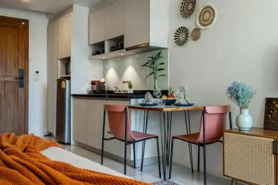 a kitchen with a table and chairs in a room at Spacious studio with big patio ! in Rawai Beach