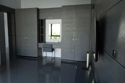 a room with a chair and a window at Villa Wallaya with pool in Bang Tao in Ban Pak Lak
