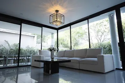 a living room with a couch and a table at Villa Wallaya with pool in Bang Tao in Ban Pak Lak