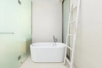 a white bath tub in a bathroom with a ladder at Taimana Luxury 3BR Private Pool Villa at LuxPride in Ban Phak Chit