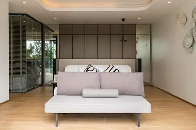 a white couch in a room with a bed at Menara Luxury 4 Bedroom Private Pool Villa BangTao in Ban Phak Chit