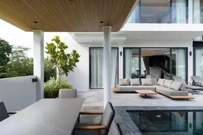 an open living room with a pool in a house at Menara Luxury 4 Bedroom Private Pool Villa BangTao in Ban Phak Chit