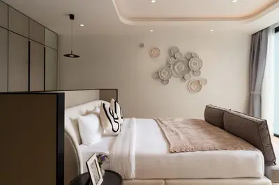a bedroom with a white bed and a couch at Menara Luxury 4 Bedroom Private Pool Villa BangTao in Ban Phak Chit