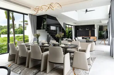 a dining room with a table and chairs at Menara Luxury 4 Bedroom Private Pool Villa BangTao in Ban Phak Chit