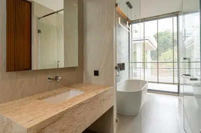 a bathroom with a sink and a mirror and a tub at Menara Luxury 4 Bedroom Private Pool Villa BangTao in Ban Phak Chit