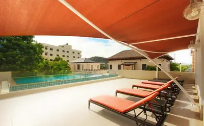 a patio with chairs and a swimming pool at Surin Sabai in Surin Beach