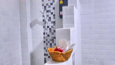 a basket of fruit sitting on a sink in a bathroom at Abbas House by Swiss Chalet, 2-room Cottages in Krabi town
