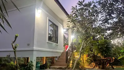 a house with stairs and plants in front of it at Abbas House by Swiss Chalet, 2-room Cottages in Krabi town