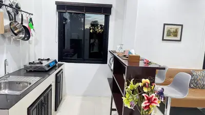 a kitchen with a sink and a counter top at Abbas House by Swiss Chalet, 2-room Cottages in Krabi town