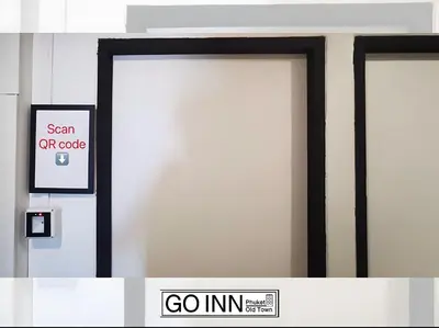 two doors in a building with a go in sign at xx GO INN Phuket Old Town in Phuket Town