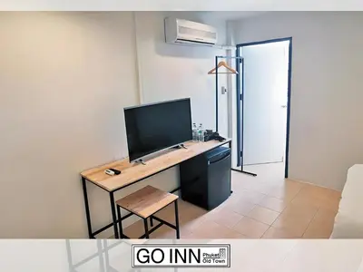 a room with a desk with a computer on it at xx GO INN Phuket Old Town in Phuket Town