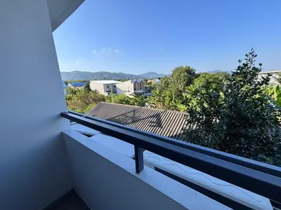 a balcony with a view of a roof at Woodbridge Property at Tower Chalong in Ban Klang