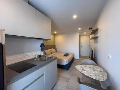 a kitchen and a bedroom with a bed in a room at Woodbridge Property at Tower Chalong in Ban Klang