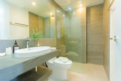 a bathroom with a sink and a toilet and a shower at Woodbridge Property at Tower Chalong in Ban Klang