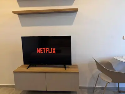 a flat screen tv sitting on top of a cabinet at Woodbridge Property at Tower Chalong in Ban Klang