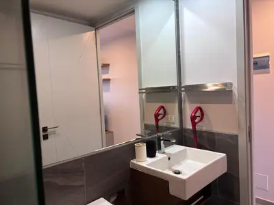 a bathroom with a sink and a mirror at Woodbridge Property at Tower Chalong in Ban Klang