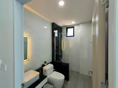 a bathroom with a toilet and a sink and a shower at Jitvirat Pool Villa in Ban Nong Chaeng