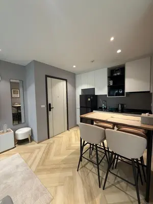 a kitchen with a table and chairs in a room at Legendary E204 - Top floor family 1BR - The Title Legendary by UNO in Ban Thalat Choeng Thale