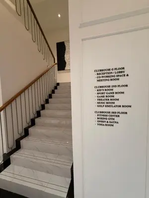 a staircase with a wall with a poem on it at Legendary E204 - Top floor family 1BR - The Title Legendary by UNO in Ban Thalat Choeng Thale