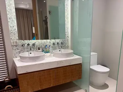 a bathroom with two sinks and a toilet at Top Pick Brand New Modern Resort Pool Villa in Laguna Phuket