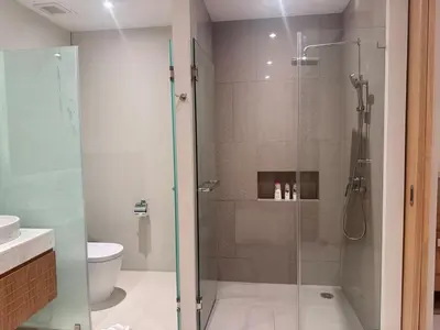a shower with a glass door in a bathroom at Top Pick Brand New Modern Resort Pool Villa in Laguna Phuket