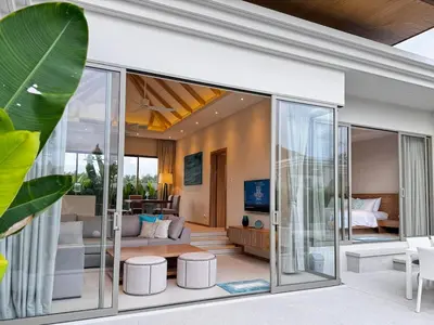 an open living room with sliding glass doors at Top Pick Brand New Modern Resort Pool Villa in Laguna Phuket