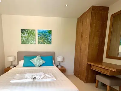 a bedroom with a bed with two towels on it at Top Pick Brand New Modern Resort Pool Villa in Laguna Phuket