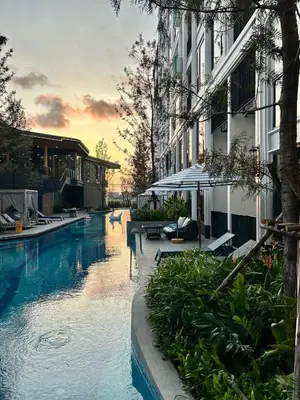 a large swimming pool next to a building at Bellevue Lagoon Boutique - Bang Tao, Phuket Laguna in Laguna Phuket
